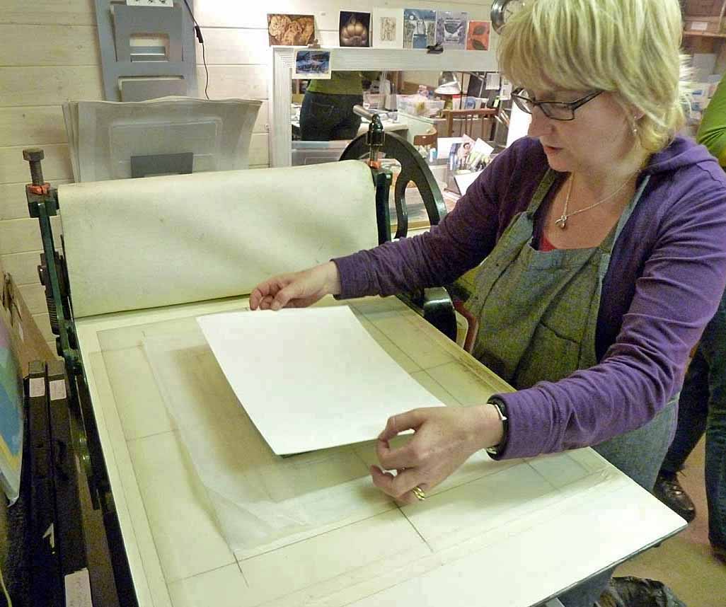 10. Positioning of dampened paper on top of inked plate