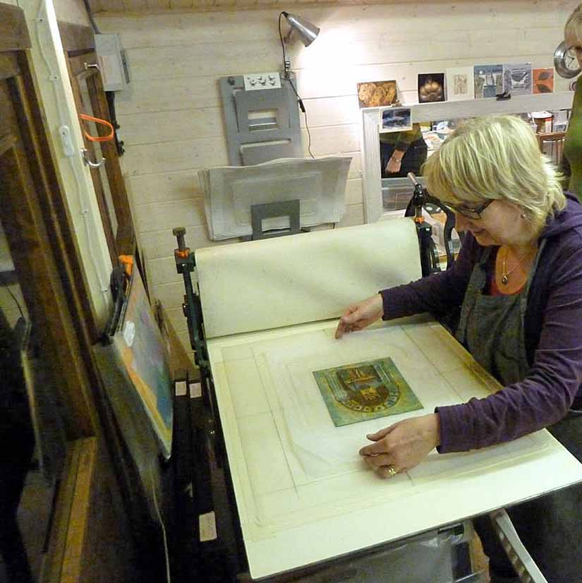 9. Placing inked plate on bed of press